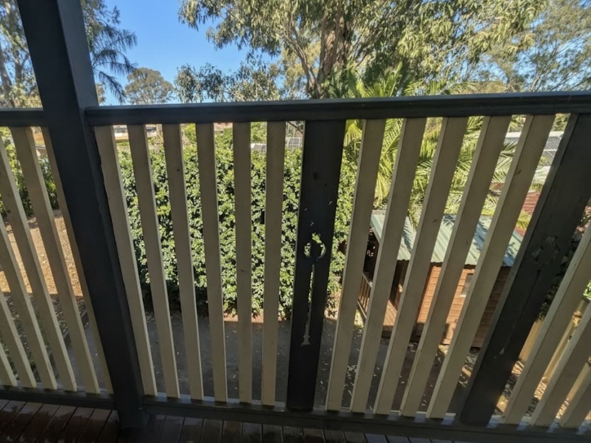 The same balcony railing, clean timber after the mould was removed